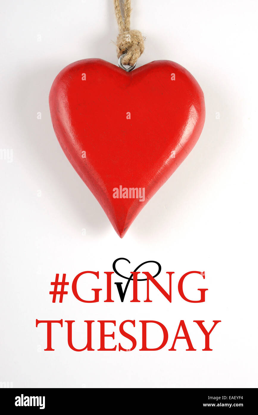 Giving Tuesday philanthropy day after Black Friday shopping message sign with red heart and sample text. Vertical. Stock Photo