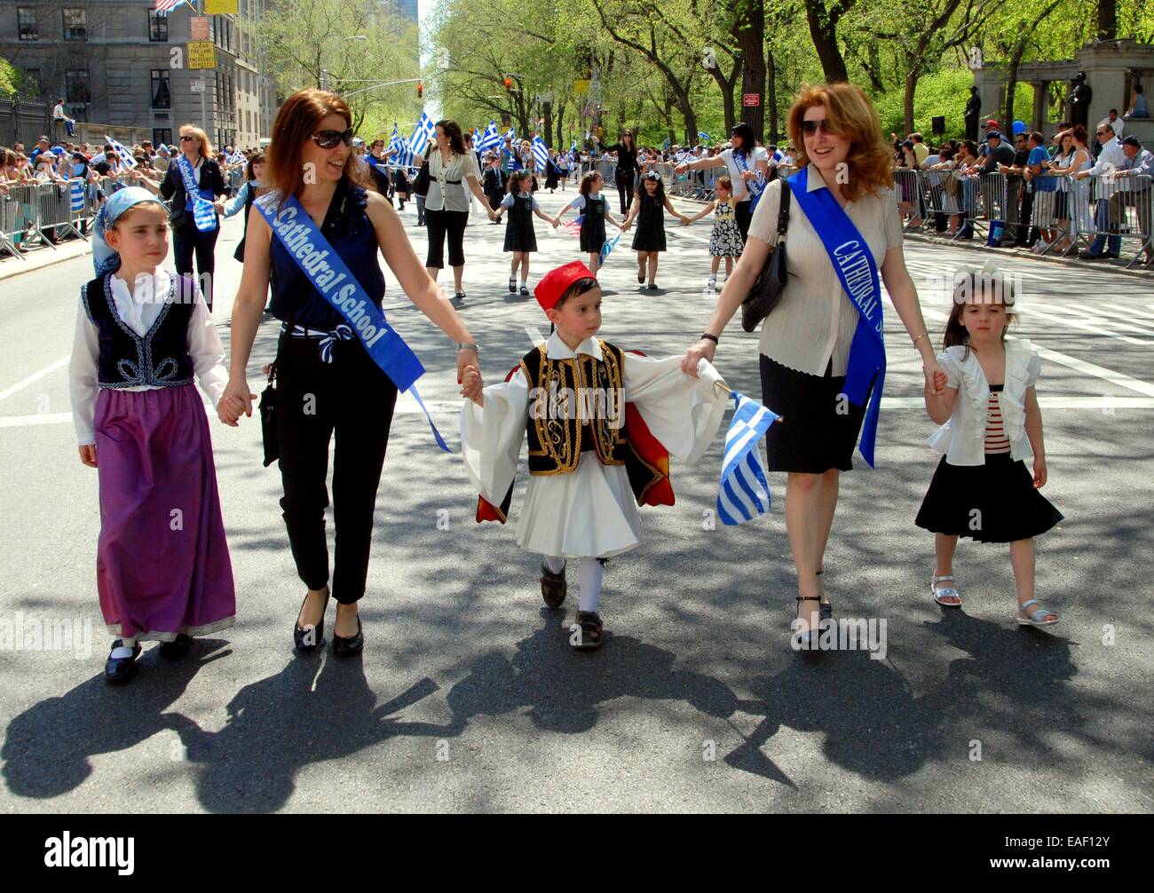 NYC:  Children in traditional Greek clothing marching with their mothers at the annual Greek Independence Day Parade on Fifth Av Stock Photo