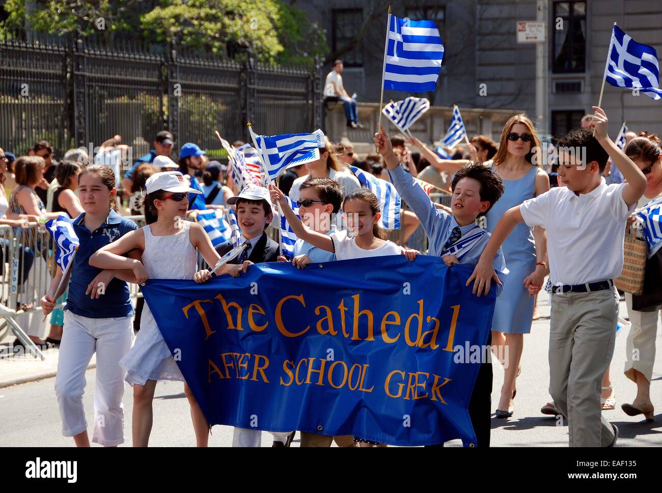 NYC:   Greek-American children carrying their school banner and waving flags marching in the Greek Independence Day Parade Stock Photo