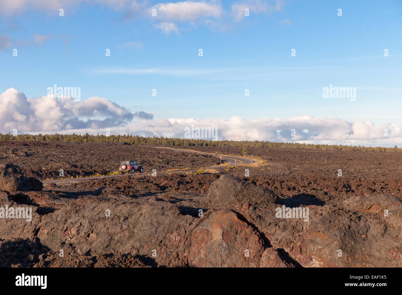 Jeep on road through lave field in Volcanos National Park Hawaii USA Stock Photo