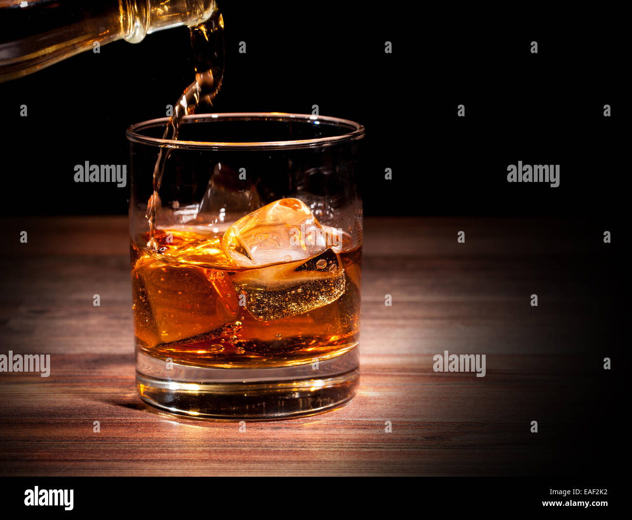Whiskey drink on wooden table, isolated on black background Stock Photo