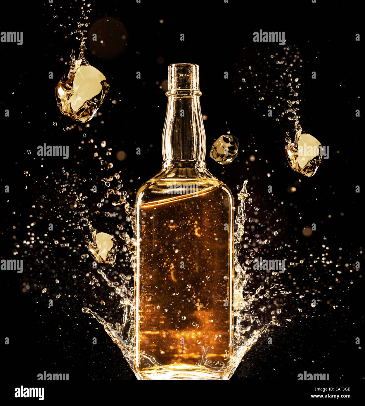 Concept of liquor splashing around bottle, isolated on black background Stock Photo