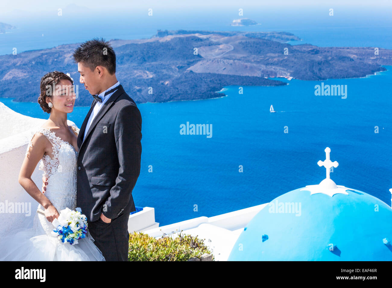 chinese wedding couple Chinese bride and groom at St Gerasimos church, Firostefani Fira Santorini Thira Cyclades islands Aegean Sea Greece EU Europe Stock Photo