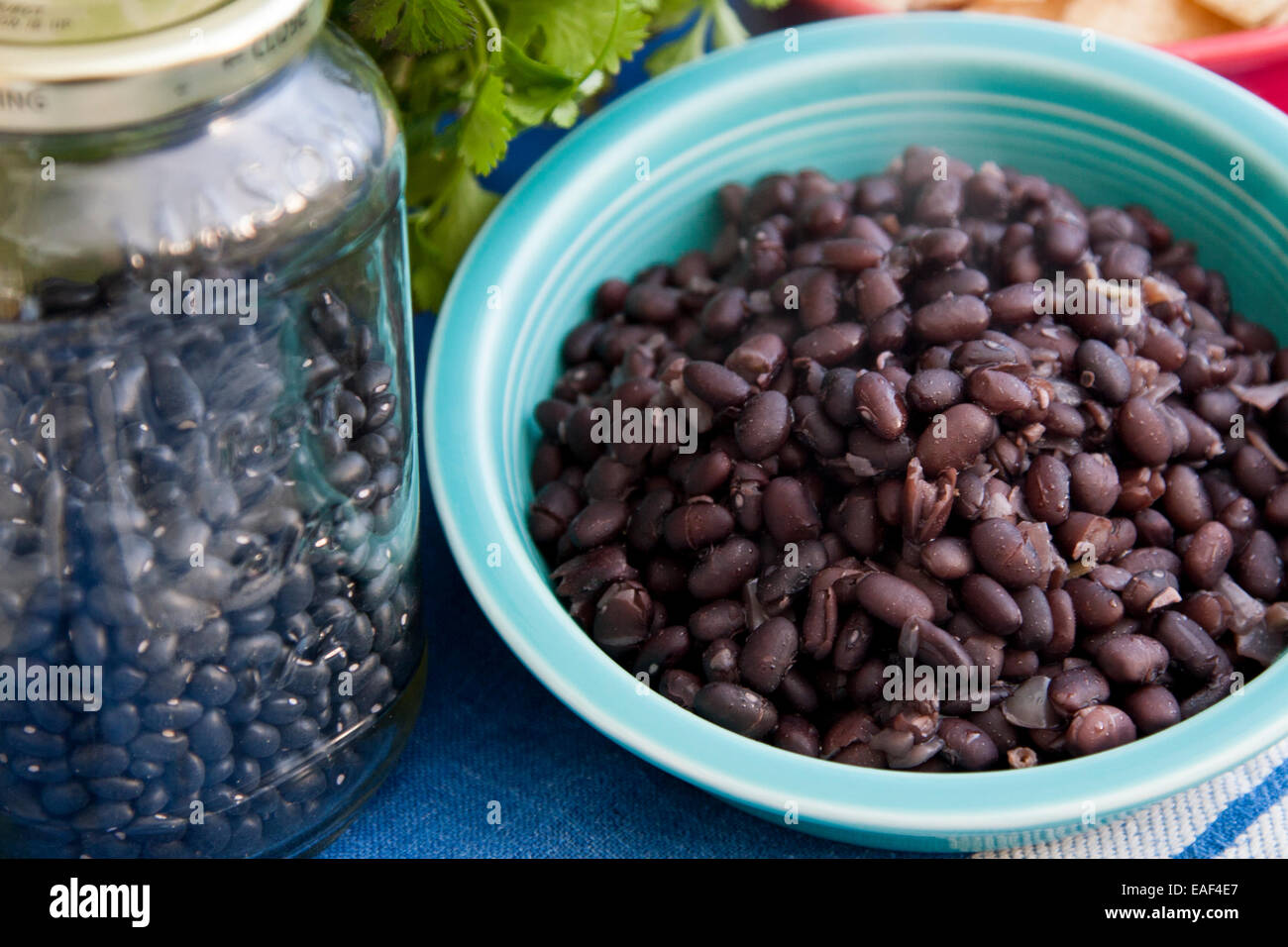 Black beans, dried in a jar, cooked in a blue bowl Stock Photo Alamy