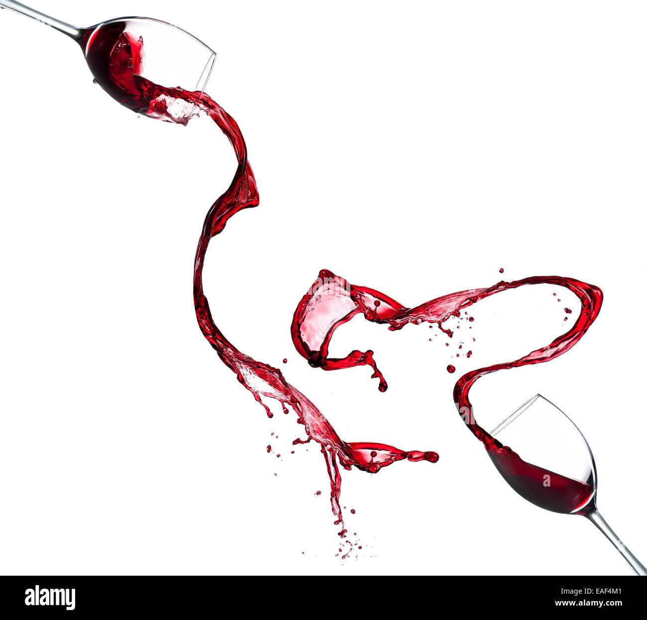 Red wine splashing from glasses, isolated on white background Stock