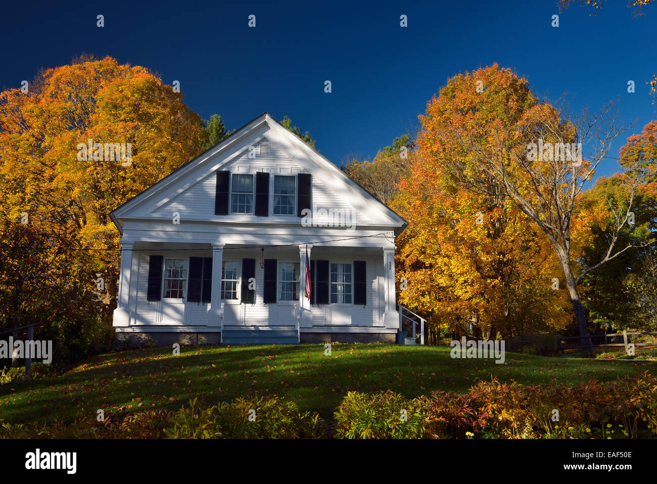 Historic Village home in Peacham Vermont with trees in Fall colors or orange Stock Photo