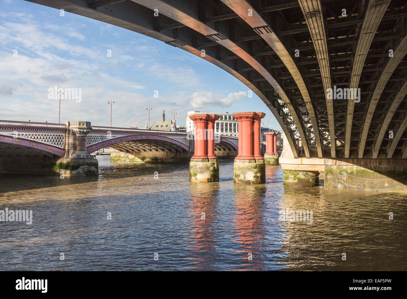 Blackfriars Bridge and underside of Blackfriars Railway Bridge, River Thames, London with columns of the former 1864 bridge Stock Photo