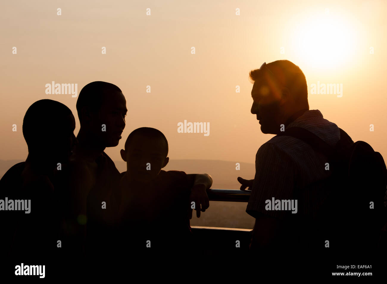 Tourists and Buddhist monks watching view at sunset from Mandalay Hill, Mandalay, Myanmar,Burma,South East Asia, Asia, Stock Photo
