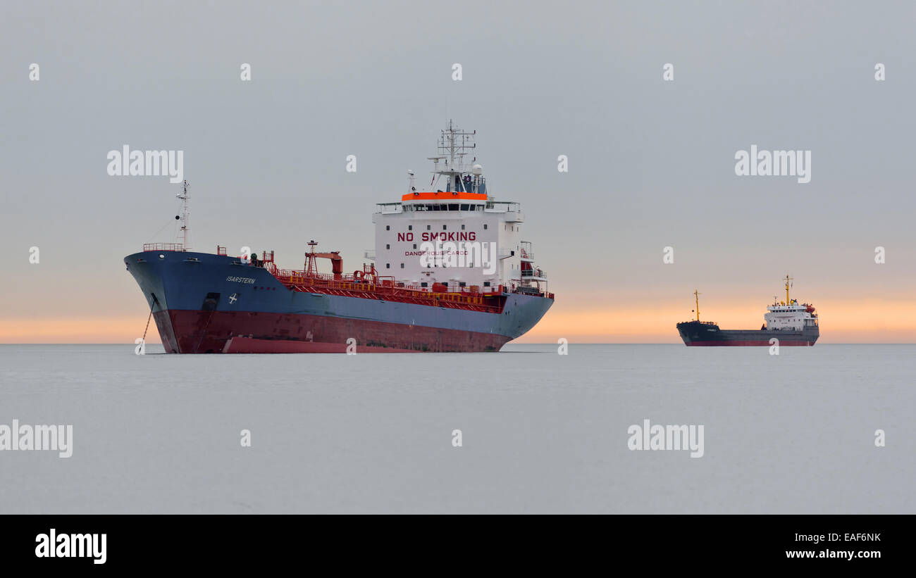 Cargo ship anchoring at sea Stock Photo