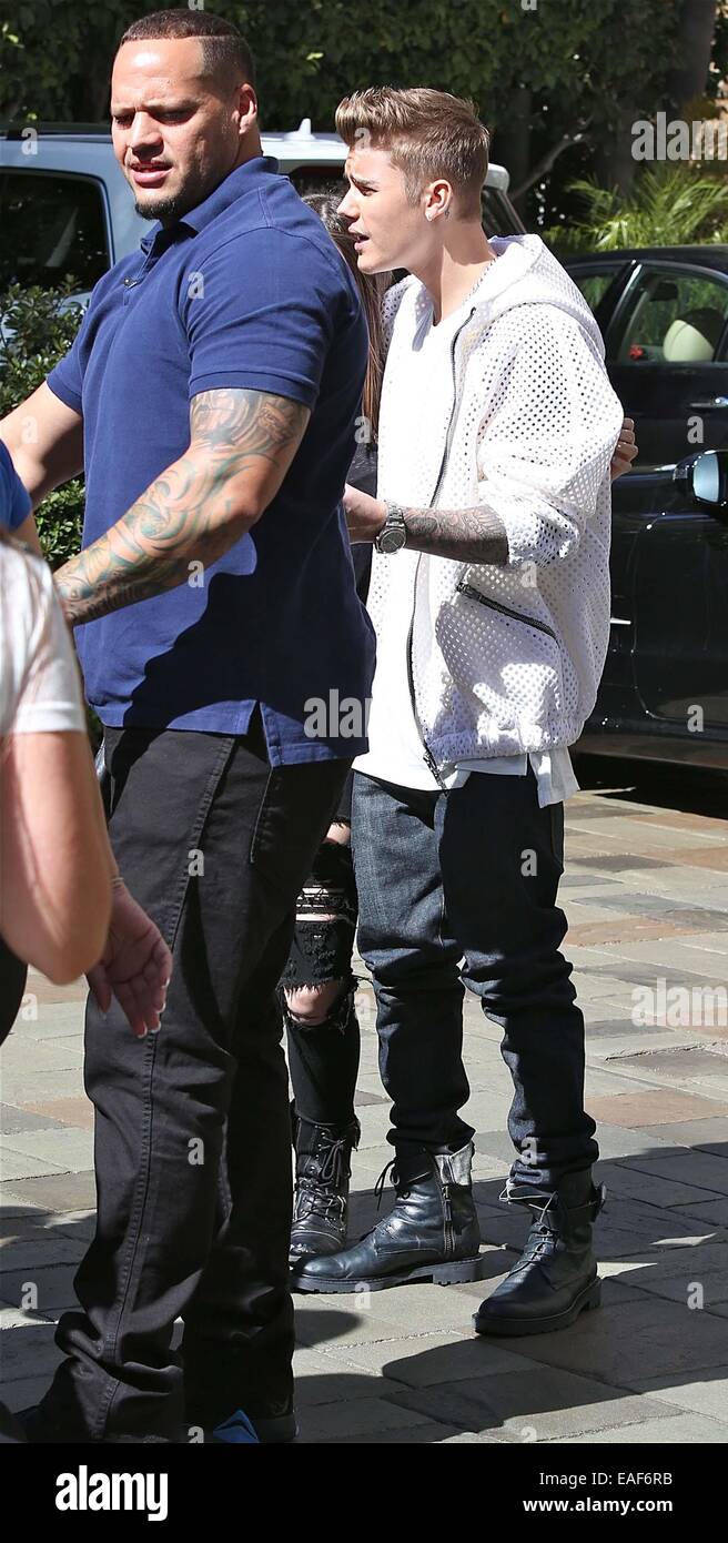 Justin Bieber in white net jumper, jeans and black combat boots leaves the  Four Seasons on