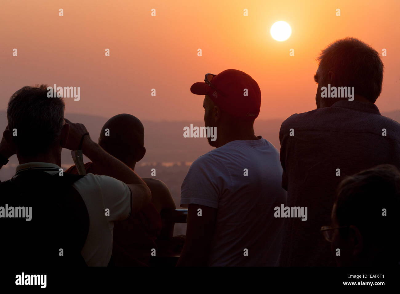 Tourists and Buddhist monks watching view at sunset from Mandalay Hill, Mandalay, Myanmar,Burma,South East Asia, Asia, Stock Photo