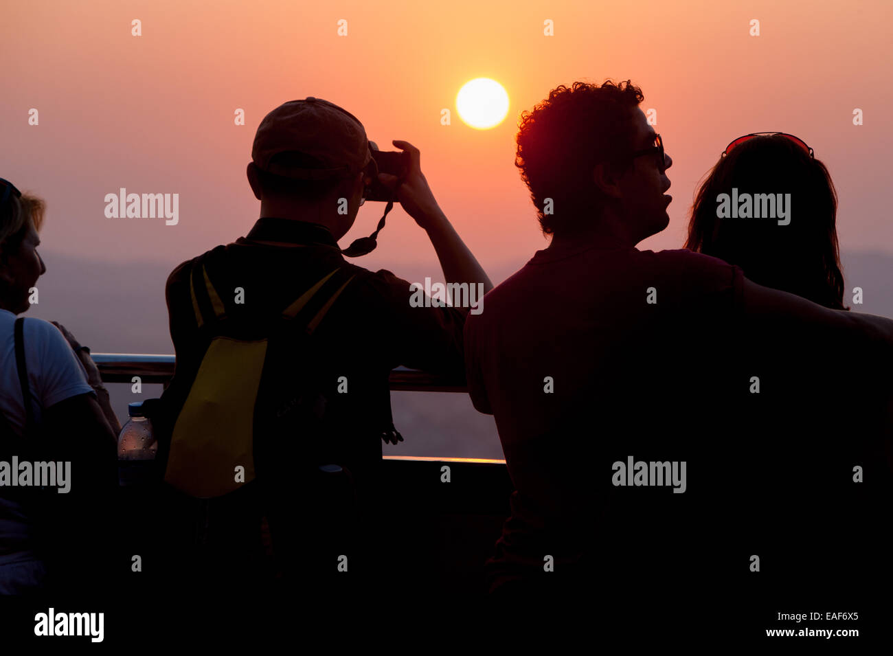 Tourists and Buddhist monks watching view at sunset from Mandalay Hill, Mandalay, Myanmar,Burma,South East Asia, Asia, Stock Photo