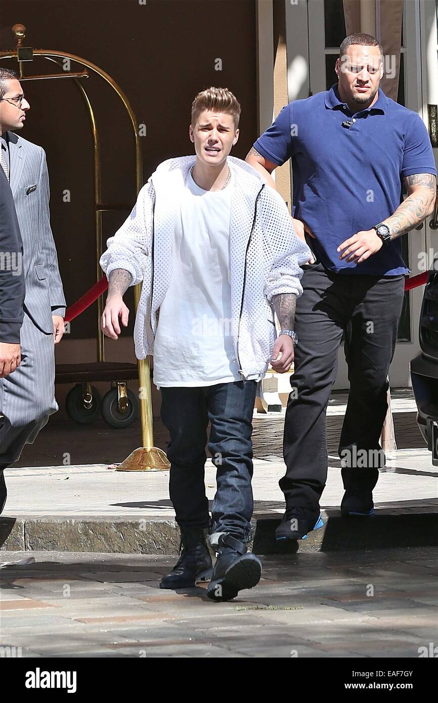 Justin in white net jumper, jeans and black combat leaves the Seasons