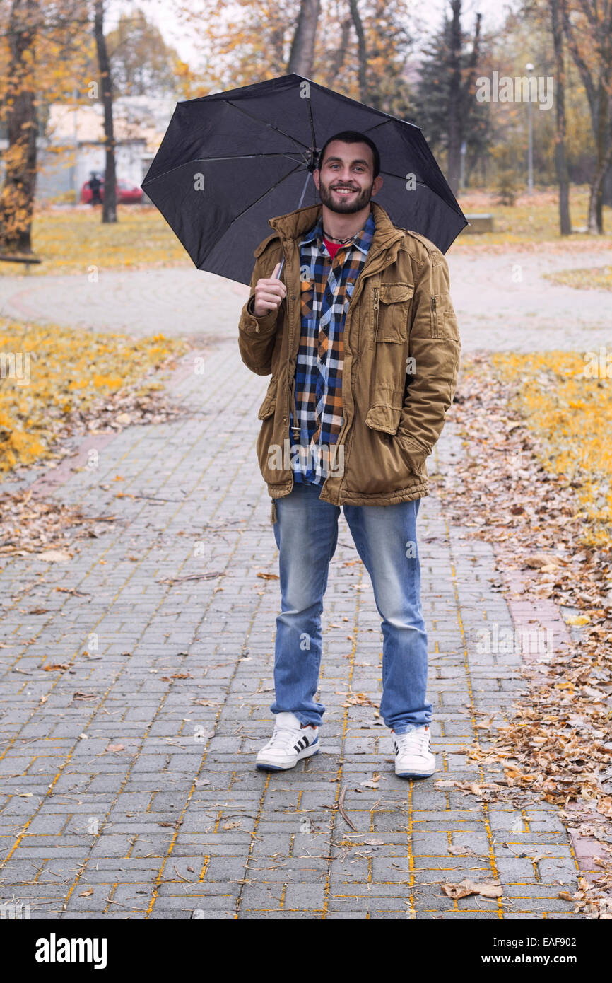 Man holding umbrella Stock Photo - Alamy