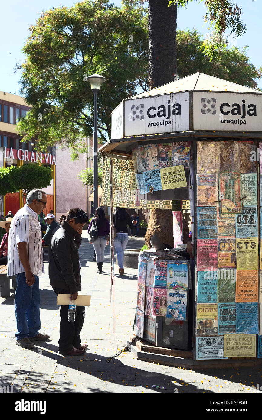 Unidentified people standing at a newspaper stand on Plaza 15 de Agosto in the morning in Arequipa, Peru Stock Photo