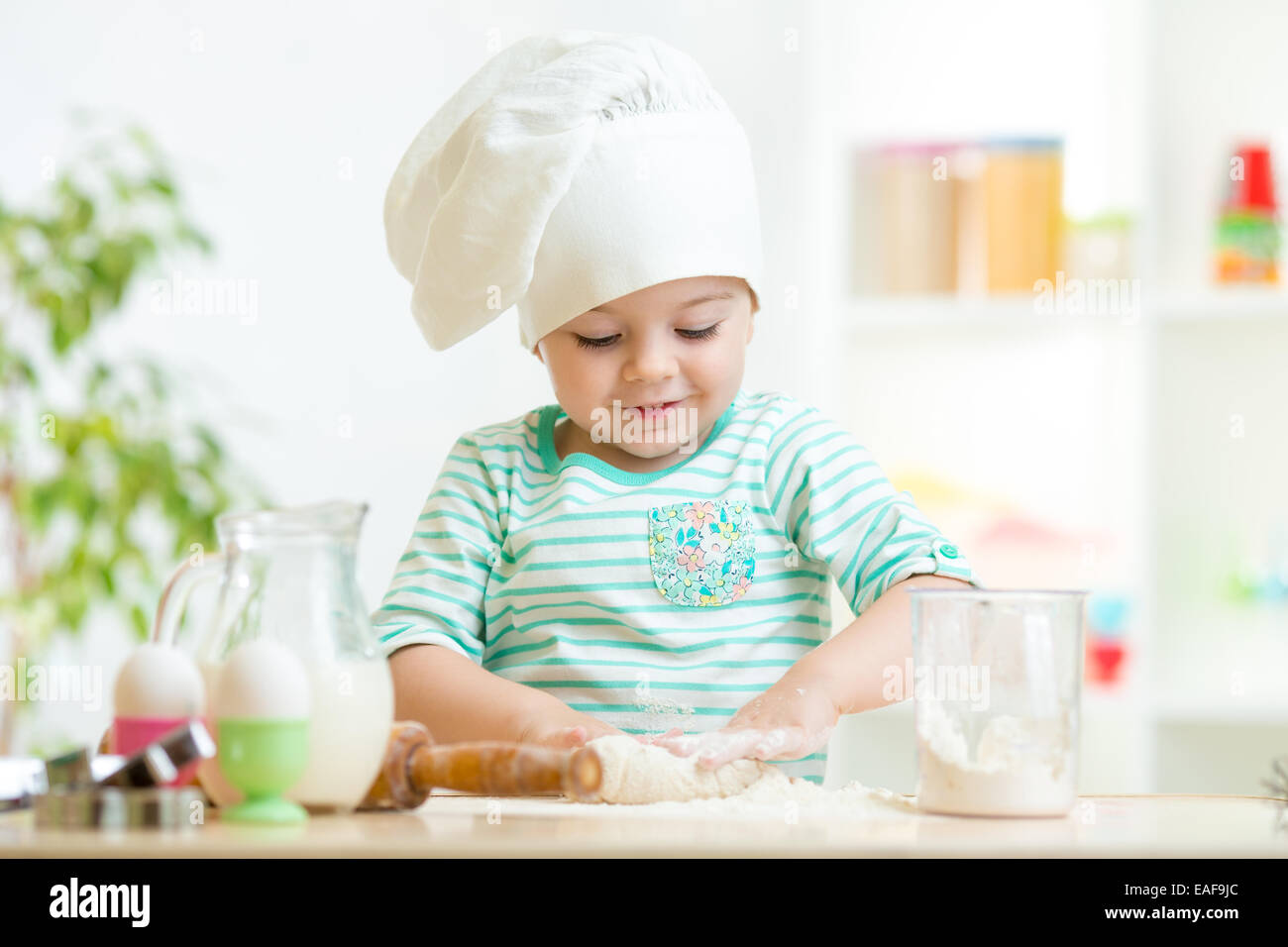 little baker kid girl in chef hat Stock Photo