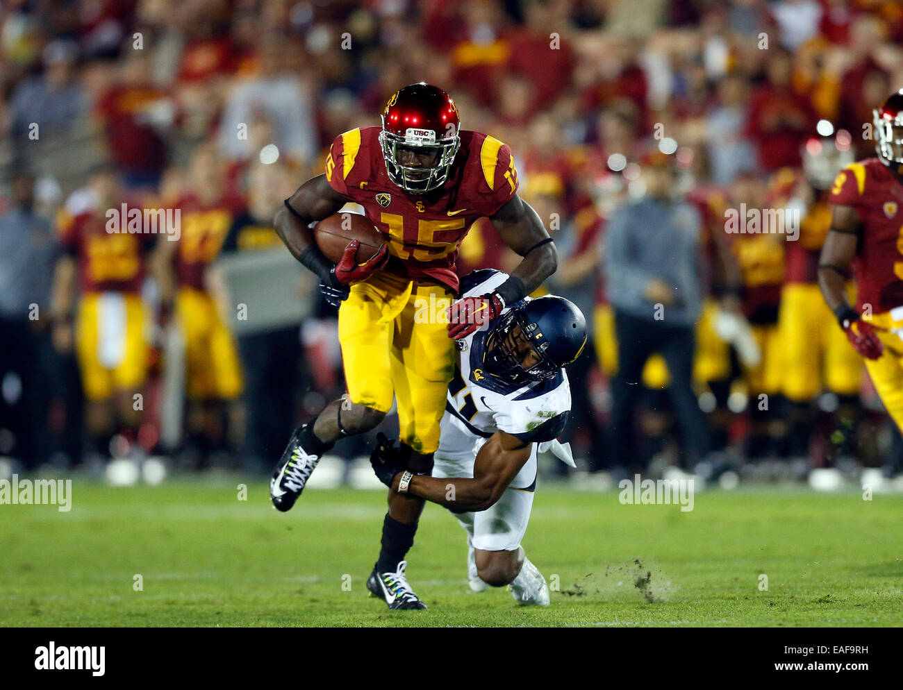 Los Angeles, CAlifornia, USA. 13th Nov, 2014. USC Trojans wide receiver Nelson Agholor #15 makes a catch and is tackled by California Golden Bears safety Stefan McClure #21 during the NCAA Football game between the California Golden Bears and the USC Trojans at the Coliseum in Los Angeles, California. Credit:  Cal Sport Media/Alamy Live News Stock Photo