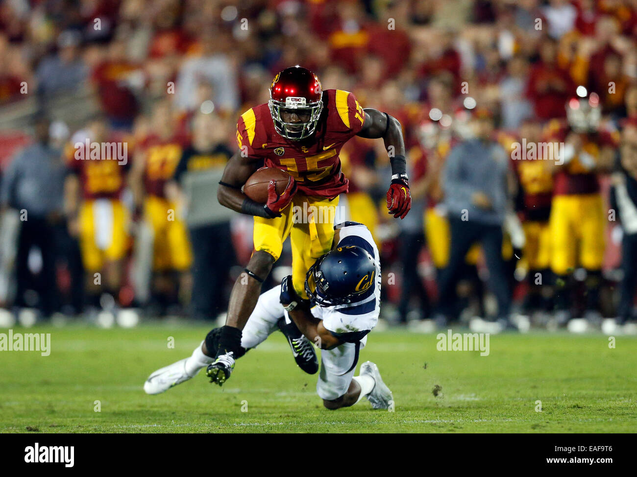 Los Angeles, CAlifornia, USA. 13th Nov, 2014. USC Trojans wide receiver Nelson Agholor #15 makes a catch and is tackled by California Golden Bears safety Stefan McClure #21 during the NCAA Football game between the California Golden Bears and the USC Trojans at the Coliseum in Los Angeles, California. Credit:  Cal Sport Media/Alamy Live News Stock Photo
