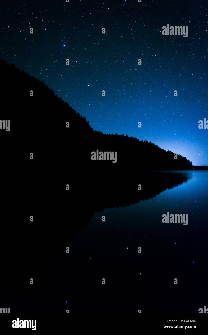 Stars in the night sky reflecting in Echo Lake, at Acadia National Park, Maine. Stock Photo