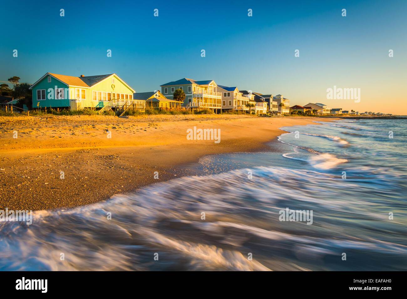 Waves in the Atlantic Ocean and morning light on beachfront homes at