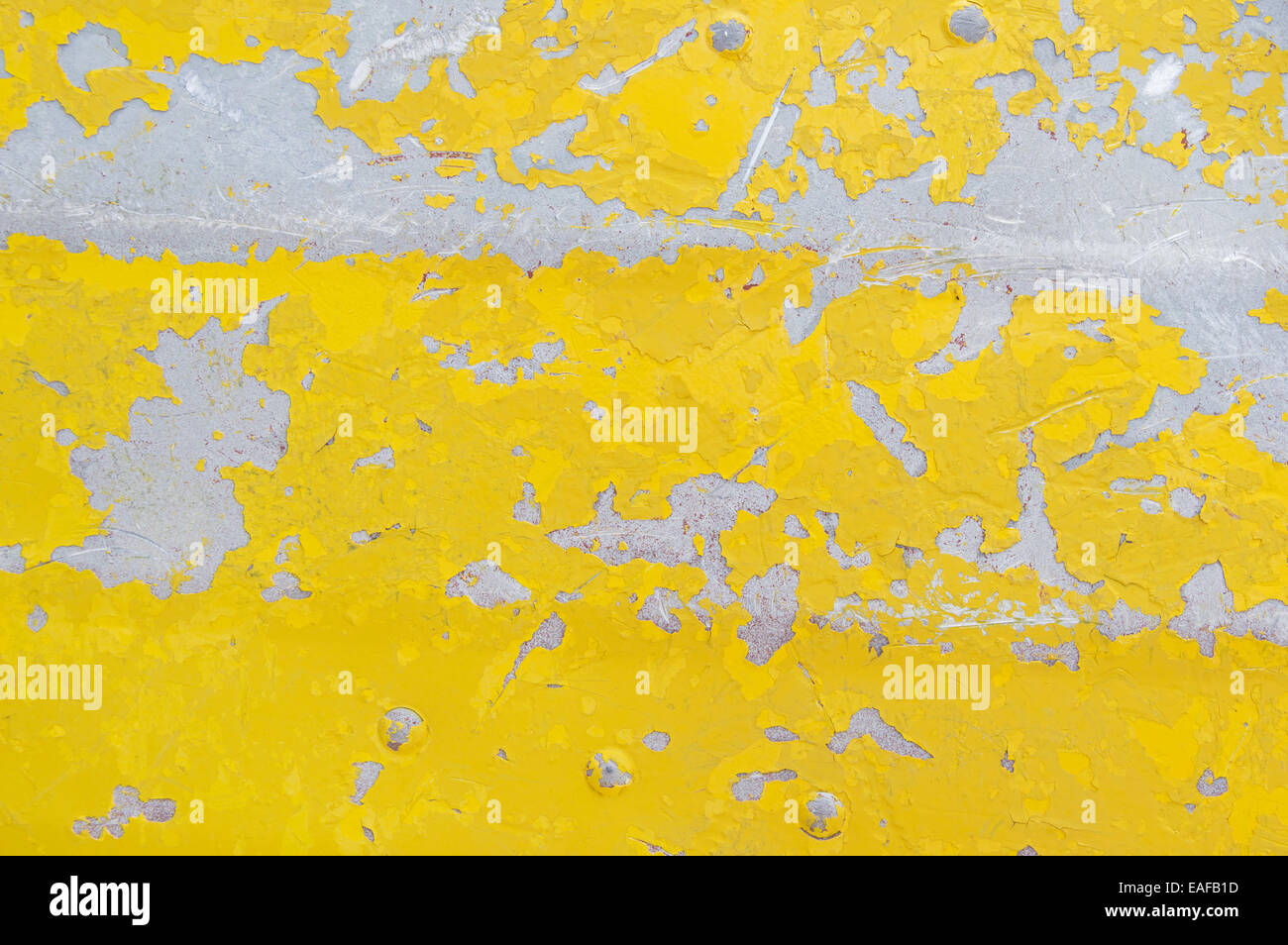 flaking yellow paint on an old aluminum boat background texture Stock Photo