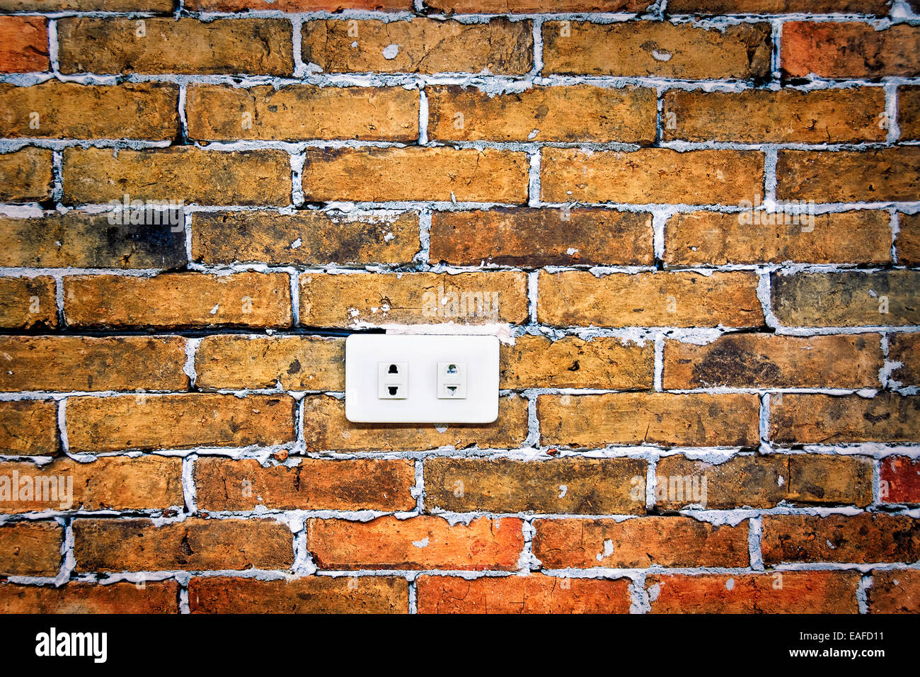 White electrical socket in grunge brick wall Stock Photo - Alamy