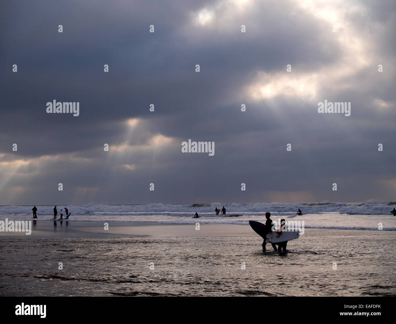 People in the sea on a wintry day, Bude, Cornwall, UK Stock Photo