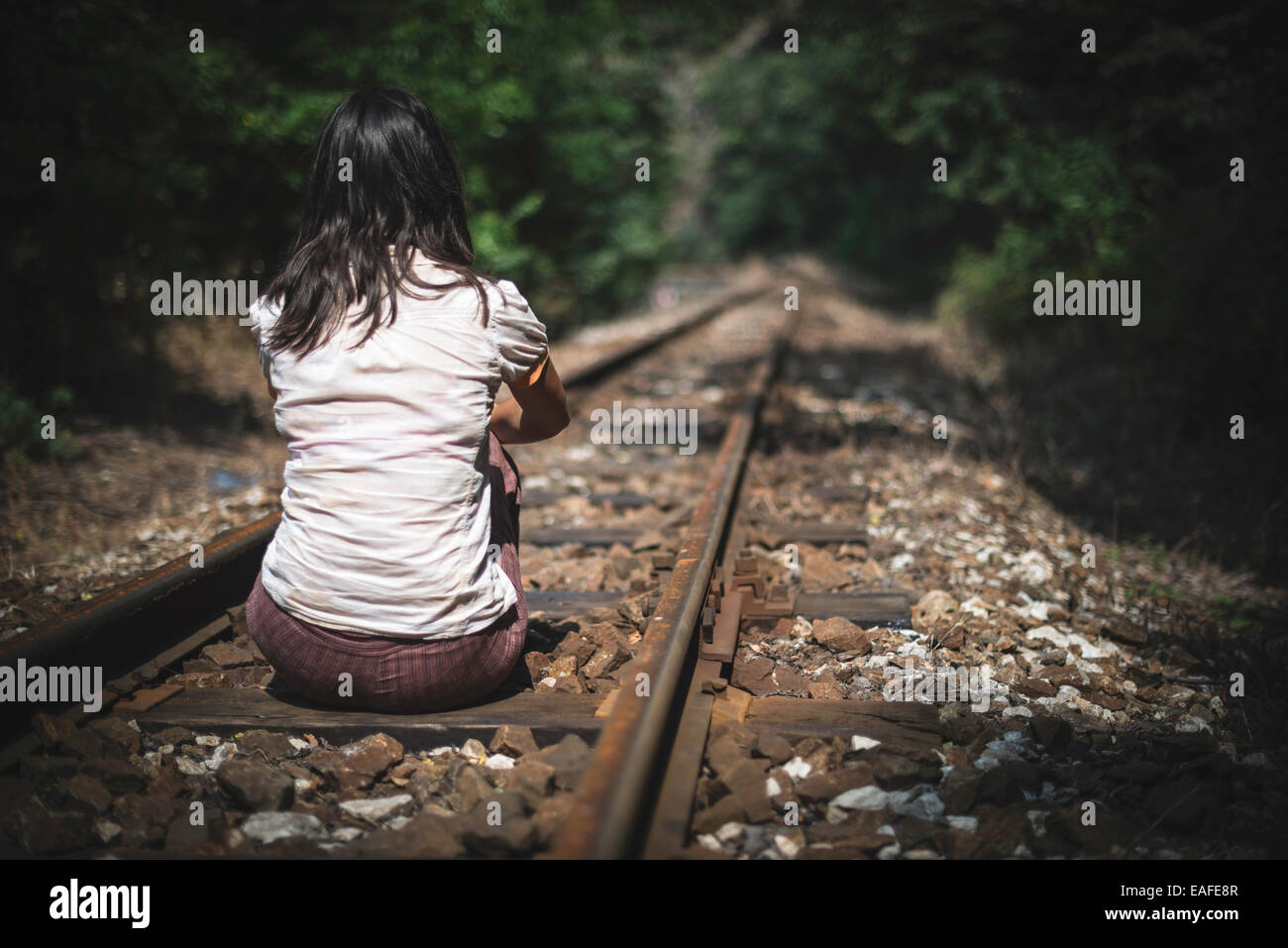 Women sitting on railroad Stock Photo - Alamy