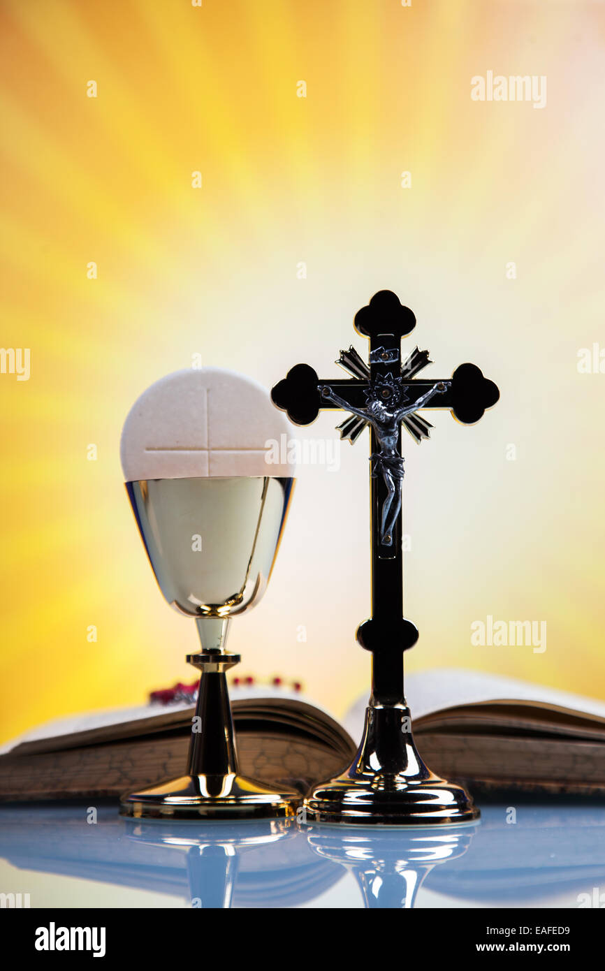 Christian religion, wine, bread and the word of God on yellow background Stock Photo