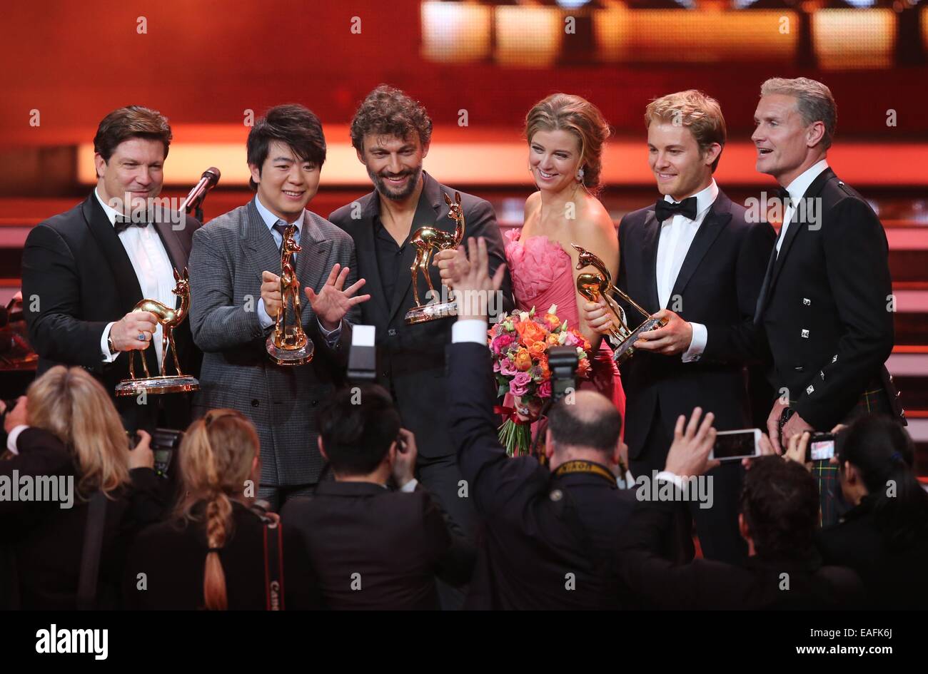 Berlin, Germany. 13th Nov, 2014. The awardees (L-R) Francis Fulton-Smith, Lang Lang, Jonas Kaufmann, eulogist Nina Eichinger, awardee Nico Rosberg and eulogist David Coulthard pose on stage after the Bambi Award ceremony at the Stage Theater on Potsdamer Platz in Berlin, Germany, 13 November 2014. The gala for the 66th Bambi Awards hosted by Hubert Burda Media took place on 13 November 2014. Photo: Wolfgang Kumm/dpa/Alamy Live News Stock Photo