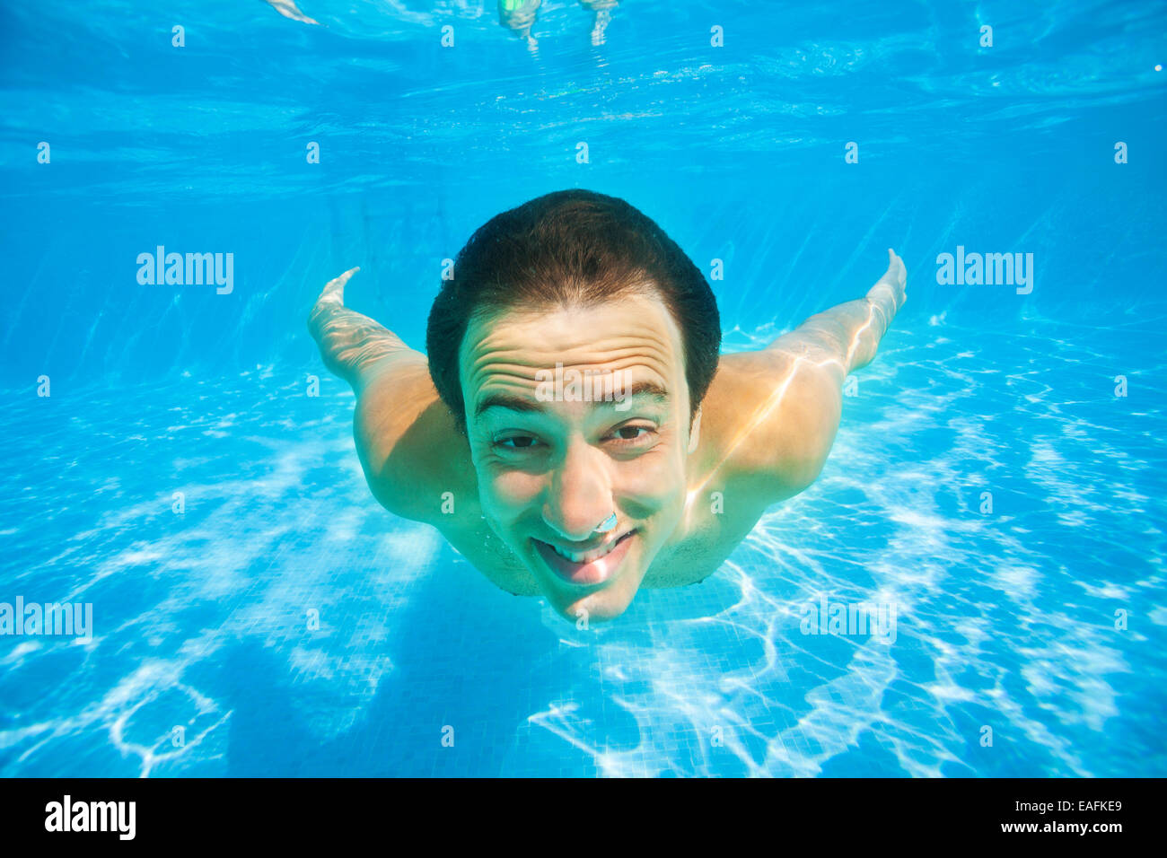 Close up view happy man swimming underwater Stock Photo