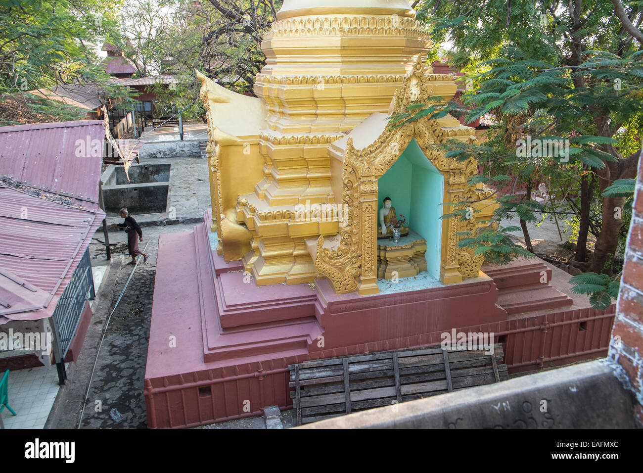 Gold pagoda, roof tops and Buddhist monk on the climb up to Mandalay Hill, Mandalay, Myanmar,Burma, South East Asia, Asia, Stock Photo
