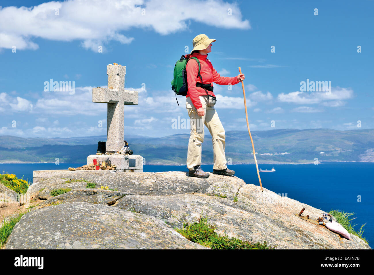 Spain, St. James Way: St. James pilgrim looking to the ocean at Cape Finisterra Stock Photo