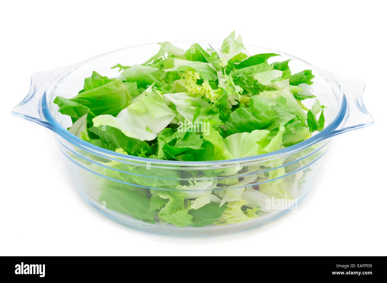 a glass bowl with mesclun, a mix of assorted salad leaves, on a white background Stock Photo