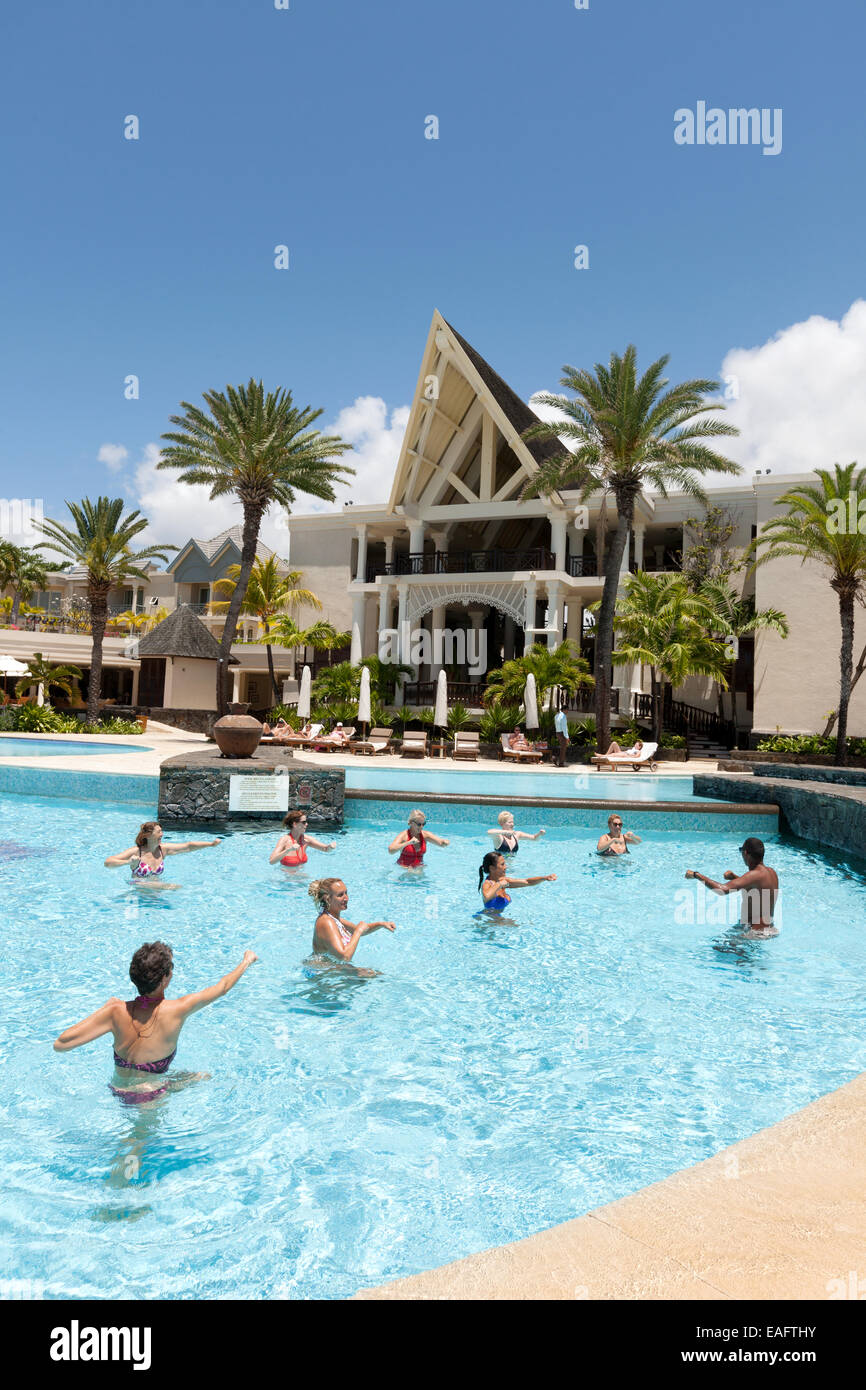 Hotel guests doing a water aerobics class in the pool at The Residence, a 5 star luxury hotel, Belle Mare, Mauritius Stock Photo