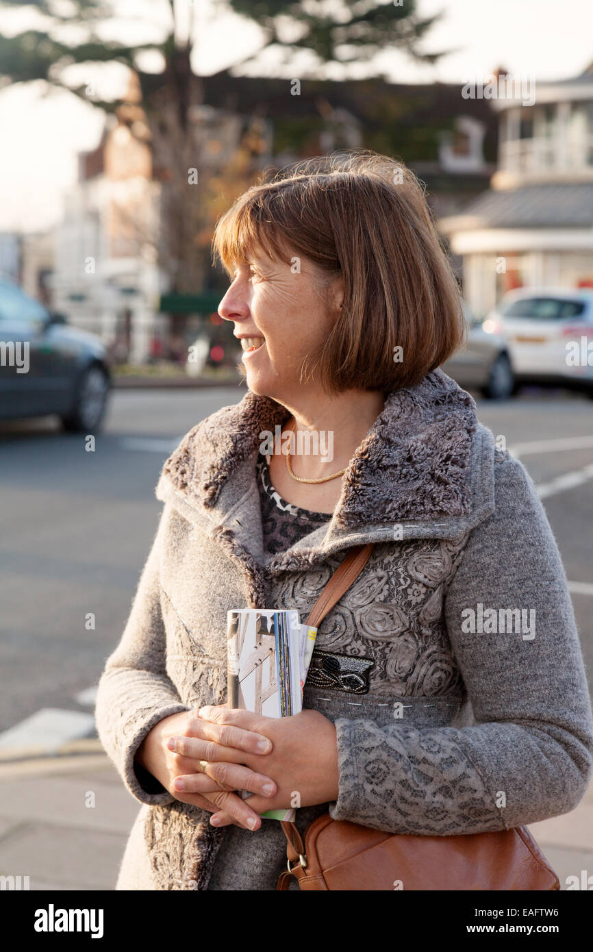 Middle aged caucasian woman in her 50s, three quarter length image, looking to left of image Stock Photo