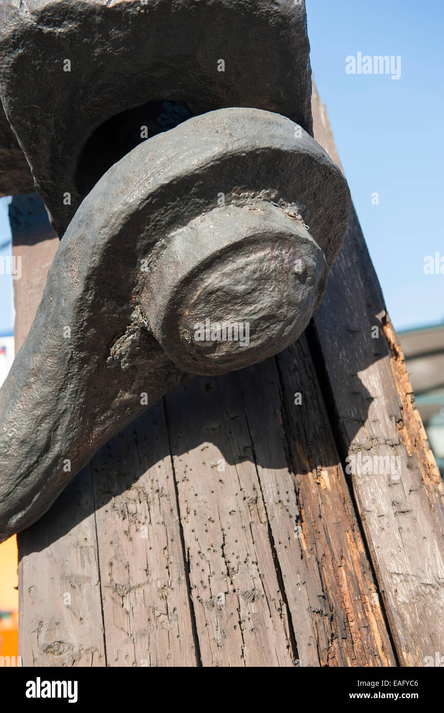Closeup detail of old marine shackle on rotting wooden mast Stock Photo