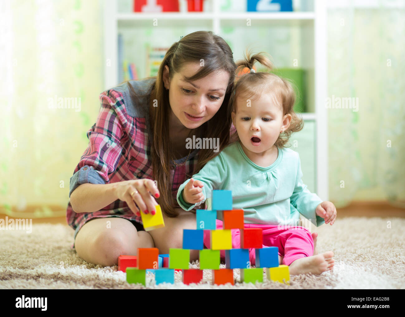 mom with her daughter play together Stock Photo