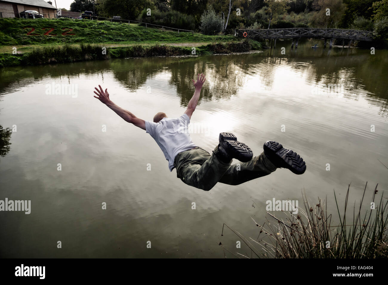 Man jumps into fishing lake. Stock Photo