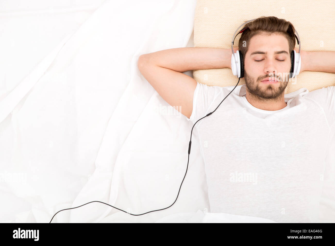 Man sleeping in bed headphones hi res stock photography and images Alamy