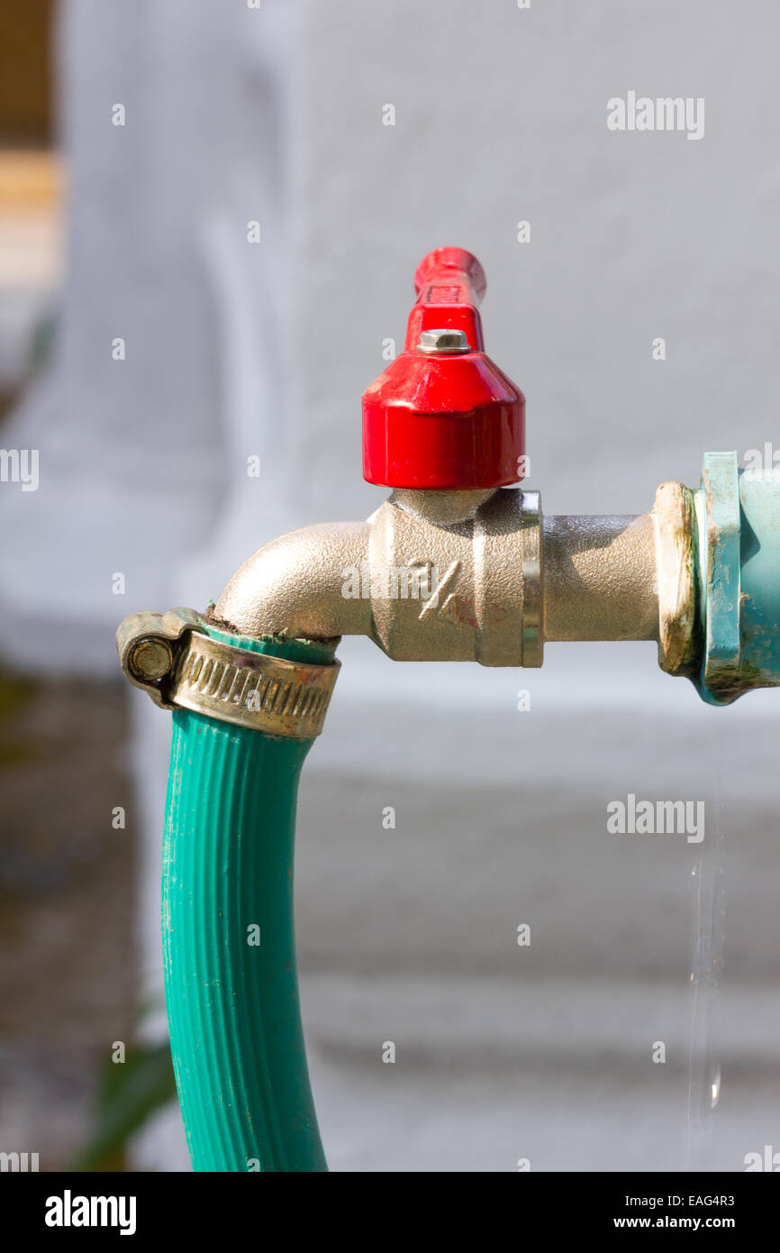 Faucet with green rubber tube Stock Photo