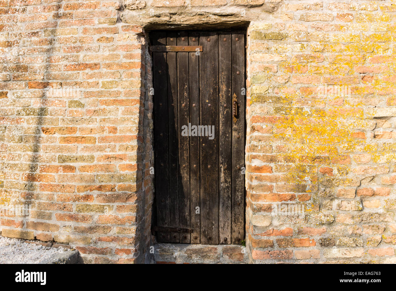 Door in the brick walls of the medieval Fortress of Venetians in Brisighella Stock Photo