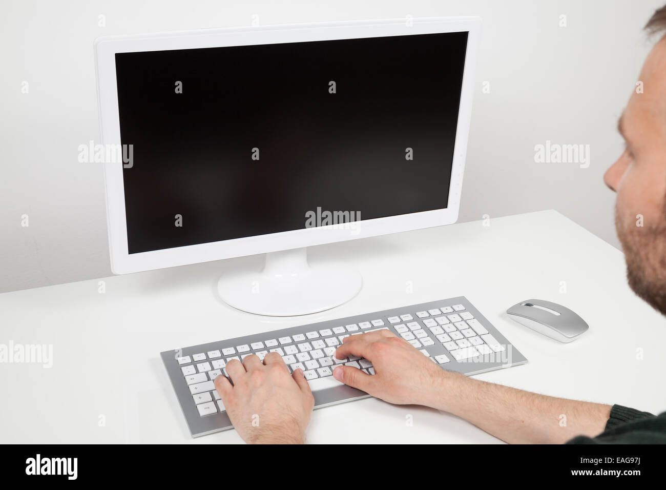 man typing on a computer Stock Photo