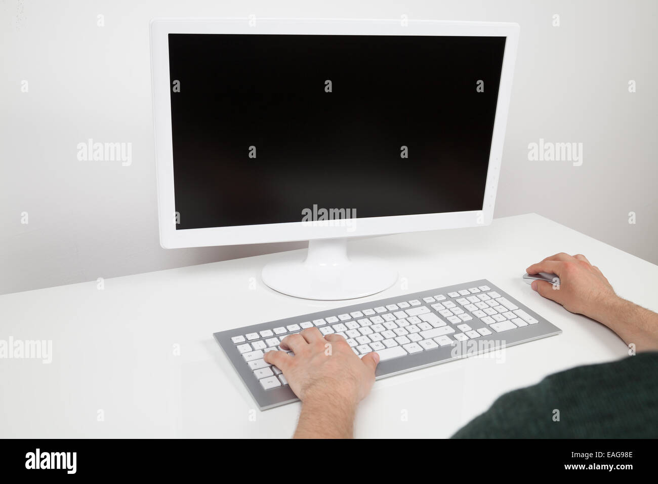 man typing on keyboard of a computer Stock Photo