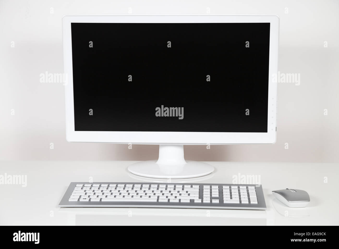 computer monitor and keyboard on white desk Stock Photo