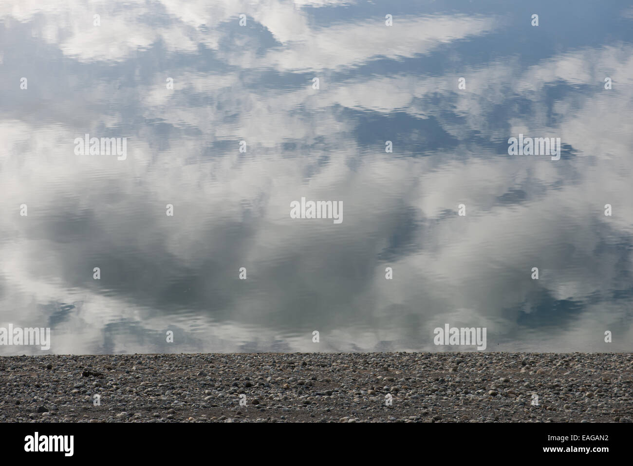 Delirium Heavy clouds over flat landscape reflected in the water Stock Photo
