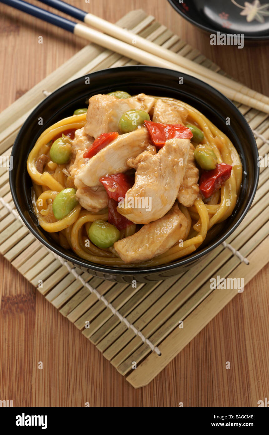 Teriyaki chicken with noodles edamame and red peppers Stock Photo