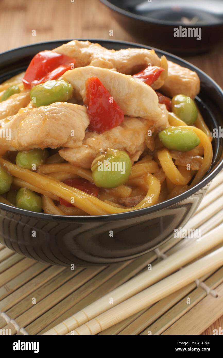 Teriyaki chicken with noodles edamame and red peppers Stock Photo