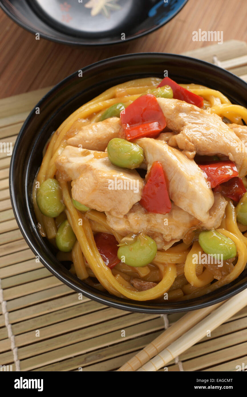 Teriyaki chicken with egg noodles edamame and red peppers Stock Photo
