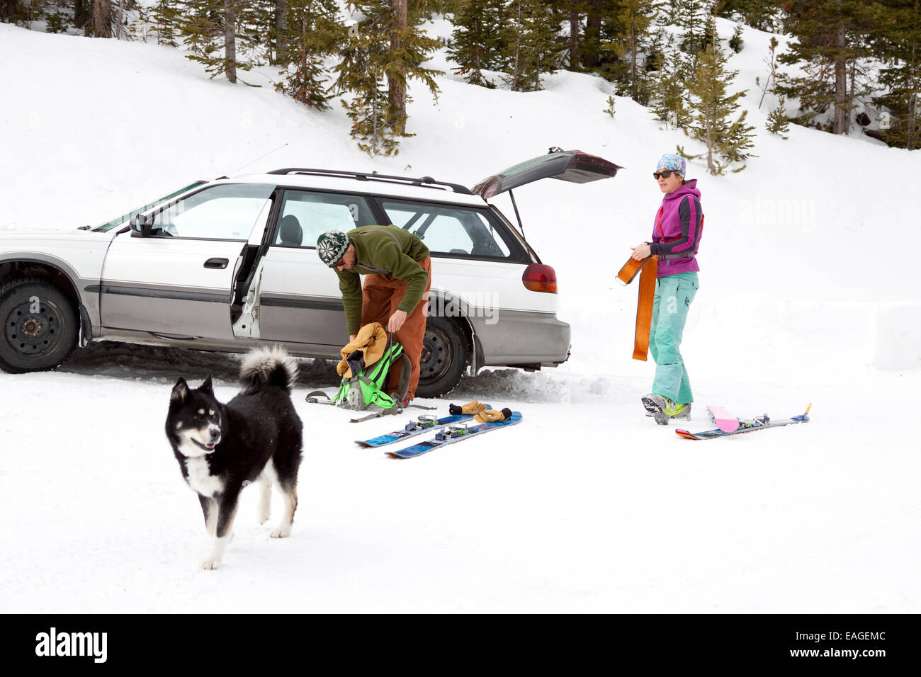 Two backcountry skiers put on their skins before heading in the Beehive Basin near Big Sky, Montana. Stock Photo